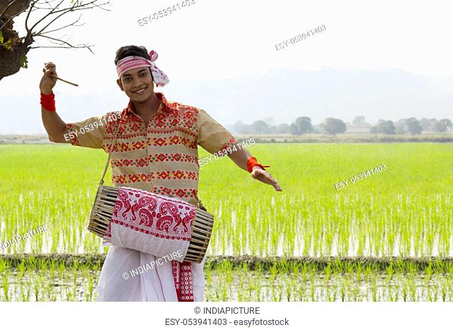 Portrait of Bihu man playing on a dhol