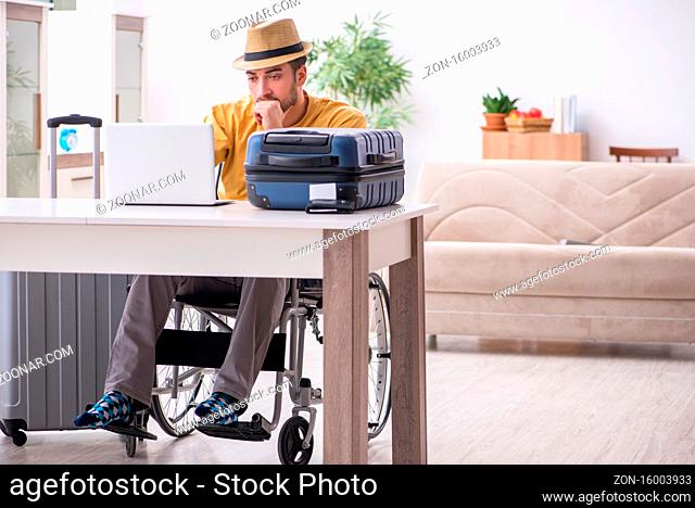Young man in wheel-chair preparing for departure
