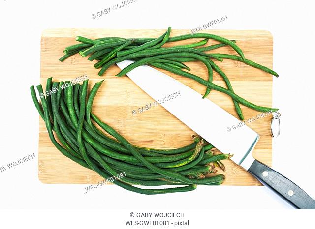 Asparagus beans on chopping board, elevated view