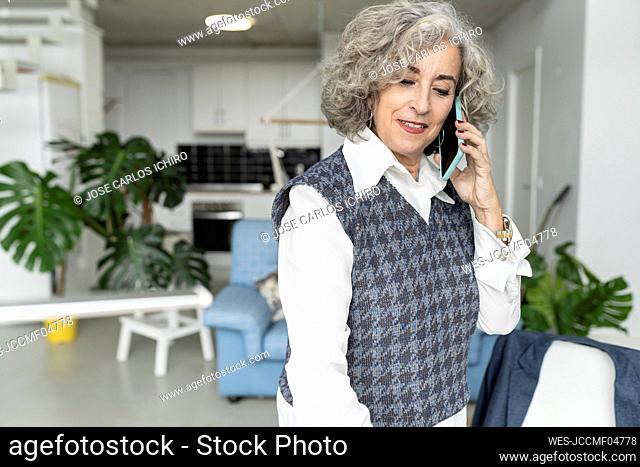 Senior businesswoman talking on mobile phone at home office