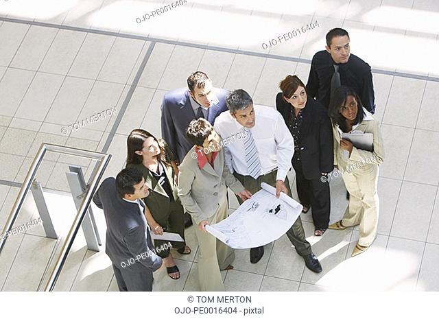 Group of businesspeople with blueprints