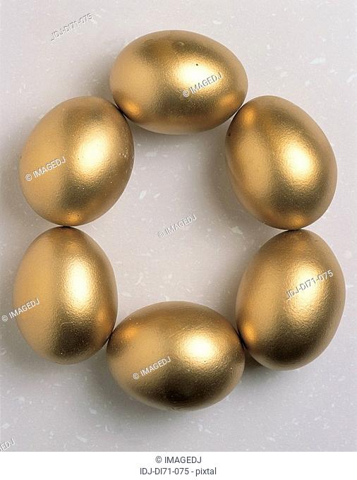 Six golden eggs form a round-shape