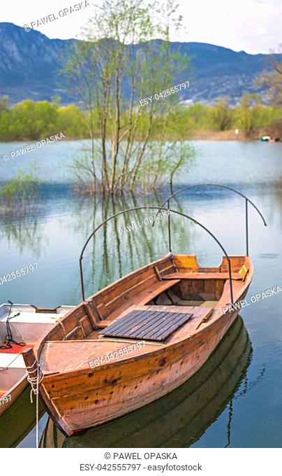 Neglected empty wooden fisherman boat on the shore of lake Skadar in Virpazar, Montenegro
