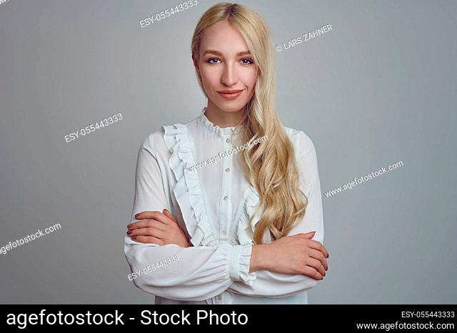 young woman, smiling, arms crossed