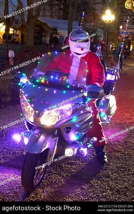 17 December 2023, Rhineland-Palatinate, Bad Neuenahr: A ""Riding Santa"", Santa Claus on a colorfully illuminated motorcycle, visits the Uferlichter