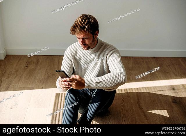 Businessman using smart phone at workplace