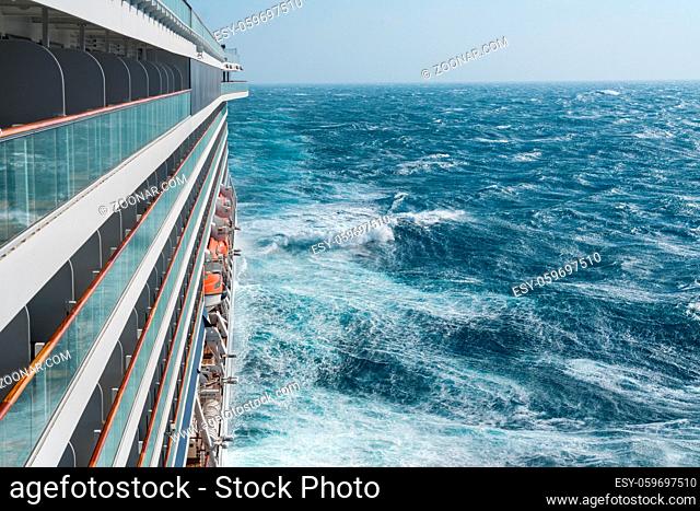 View from cabin balconies at the rough seas and waves off the side of cruise ship