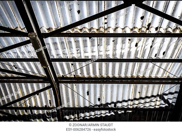 old corrugated polycarbonate roof with rusty construction