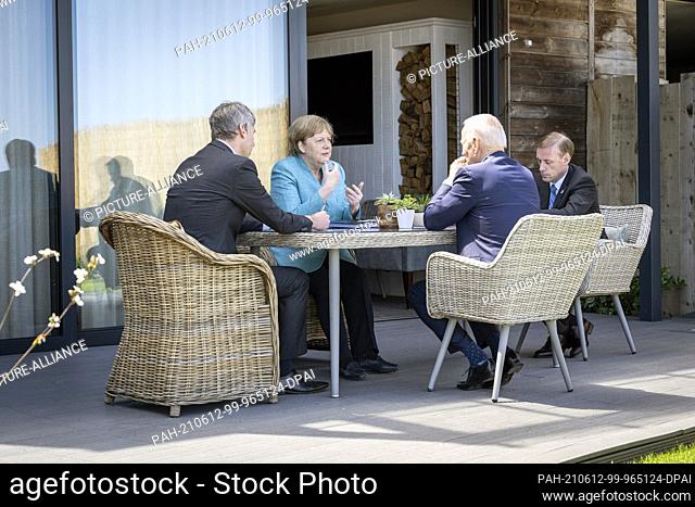 HANDOUT - 12 June 2021, United Kingdom, St.Ives: German Chancellor Angela Merkel (CDU) and US President Joe Biden (2nd from right) sit with their foreign policy...
