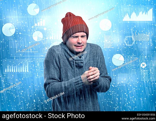 Young businessman shivering with graphs, reports and chart concept