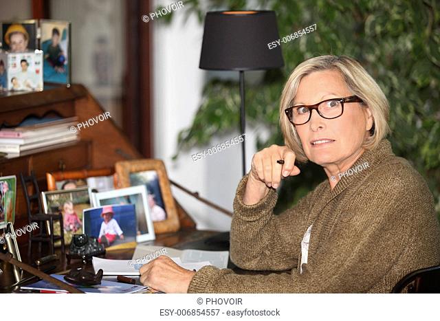 Elderly lady writing at desk