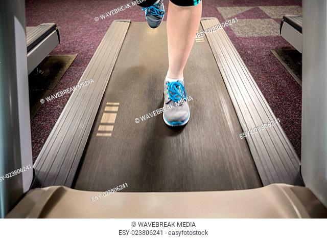Feet of woman running on treadmill