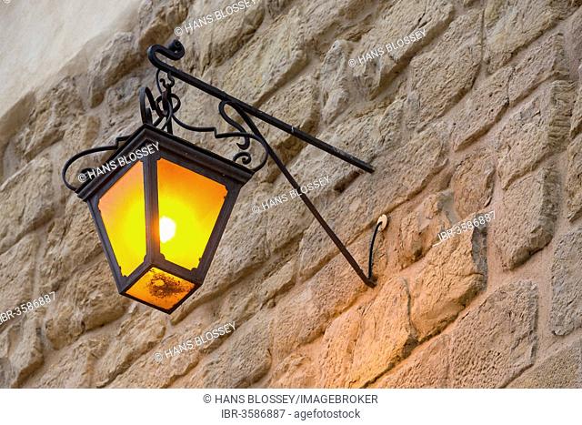 Street lamp on a stone wall, Coimbra, Centro Region, Portugal
