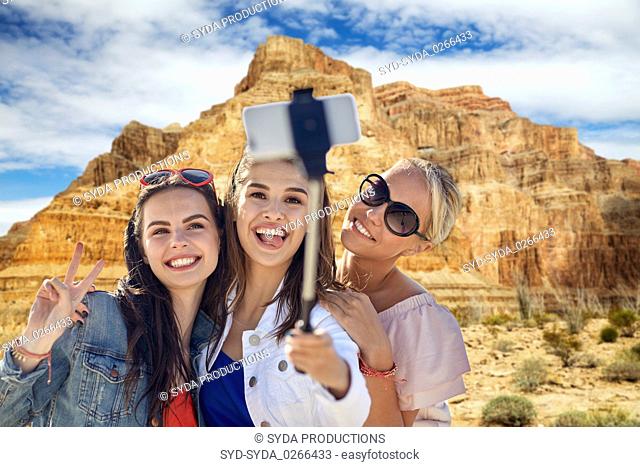 female friends taking selfie over grand canyon