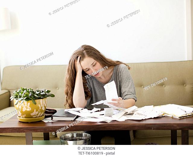 Young woman going though domestic paperwork