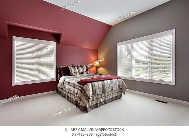 Large bedroom with maroon and gray walls