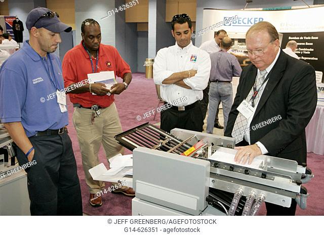 Convention Center, Graphic of the Americas, MBM Air Suction Folder, Black male buyer, demonstrate. Miami Beach. Florida. USA