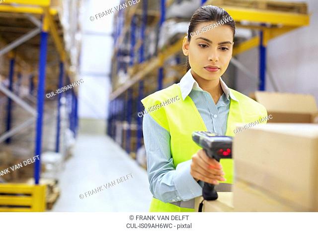 Young woman with barcode reader in distribution warehouse