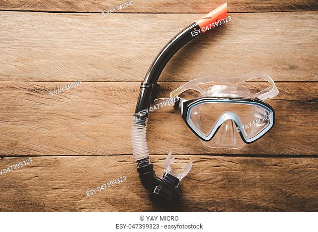 Diving Mask and Snorkel on wooden floor