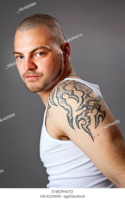 BUNDESREPUBLIK DEUTSCHLAND, BAYERN, 06.06.2010, An image of a handsome man with tattoos - Bayern, Bayern, Germany, 06/06/2010