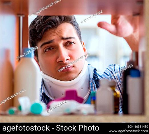 The sick ill man looking for medicines at farmacy shelf