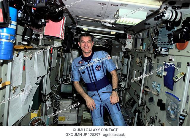 Astronaut James S. Voss, Expedition Two flight engineer, poses in his Russian flight suit in the Zarya Functional Cargo Block (FGB) module of the International...
