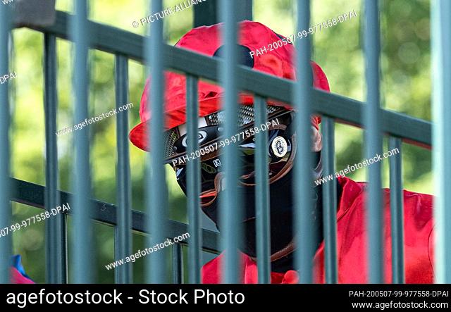 07 May 2020, Lower Saxony, Langenhagen: A jockey rides on the racetrack Neue Bult protected by a mask and glasses. At the racecourse in Langenhagen near Hanover...