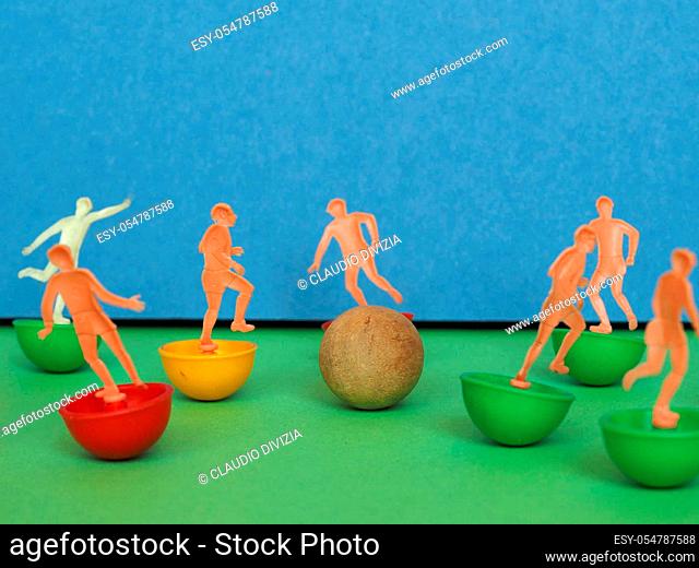 plastic toy soccer players playing football sport with wooden ball