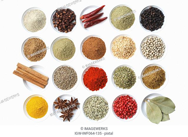 Variety of spices in bowls on white background, close-up