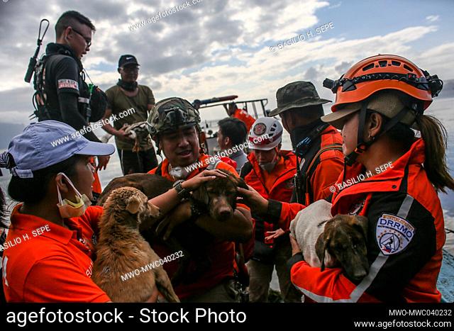 Rescue volunteers save animals that have been left behind as Taal volcano continues to spew ash and smoke In Balete, Batangas province south of Manila