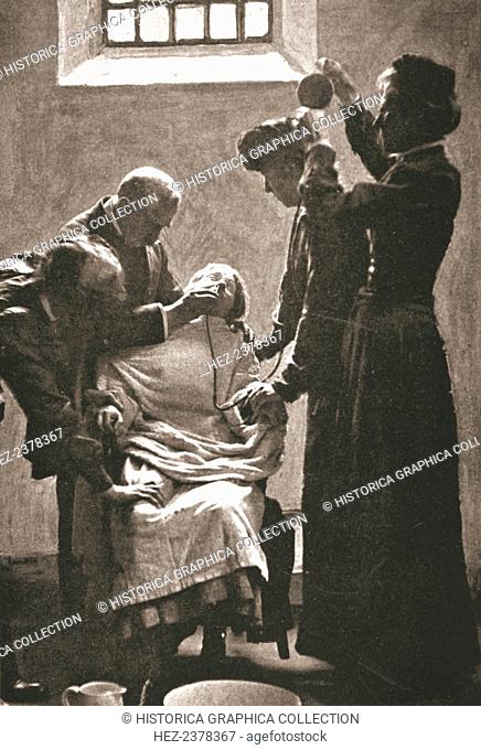 Suffragette being force fed with the nasal tube in Holloway Prison, London, 1909. In response to their hunger strikes several suffragettes were subjected to...
