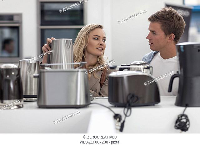 Young couple shopping kitchen equipment