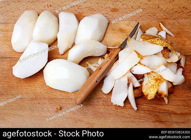 Peeled and sliced pear on a wooden board. Healthy food
