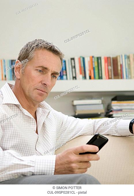 Businessman looking at his mobile phone