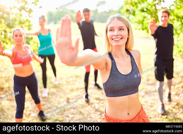Gruppe Freunde macht Aerobic im Fitness Workshop in der Natur im Sommer