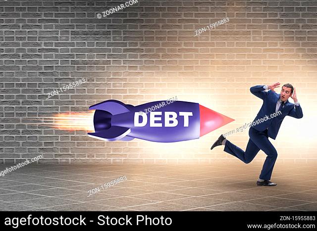 Concept of loan and debt with the businessman chased by rocket