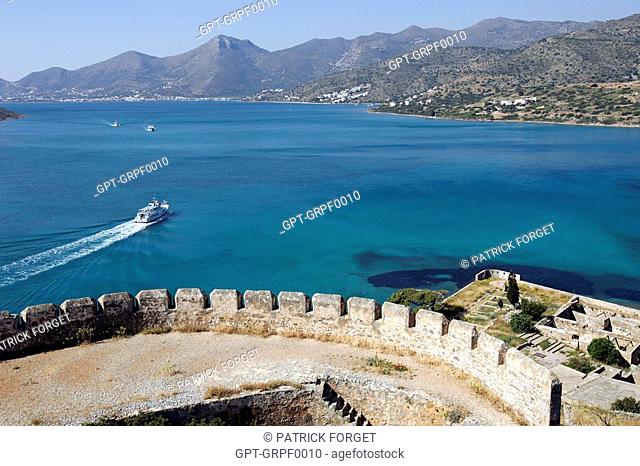 VENETIAN FORTRESS ON THE ISLE OF SPINALONGA AND BOAT IN THE GULF OF MIRABELLO, CRETE, GREECE