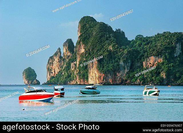 Motorboats anchored at Ao Loh Dalum beach on Phi Phi Don Island, Krabi Province, Thailand. Koh Phi Phi Don is part of a marine national park