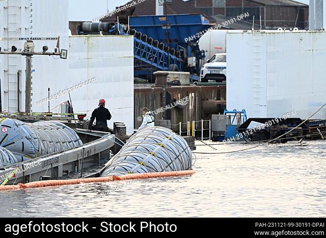 21 November 2023, Lower Saxony, Emden: Salvage specialists prepare the barge ""Sabine"", which was lifted with air bags, for docking
