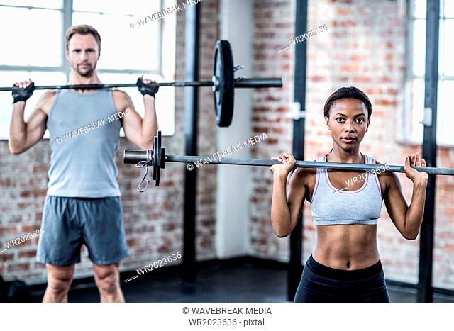 Fit couple lifting weight together