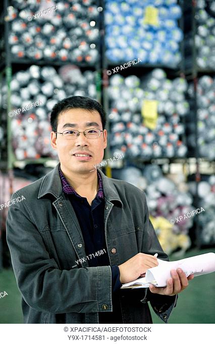 An employee at the New Wide Knitting and Dyeing Warehouse doing an inventory check