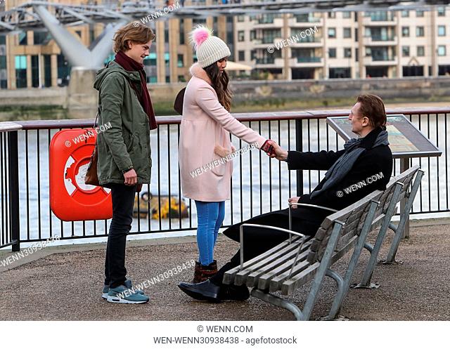 Liam Neeson, Olivia Olsen and Thomas Brodie-Sangster film a scene for a short of 'Love Actually', directed by Richard Curtis