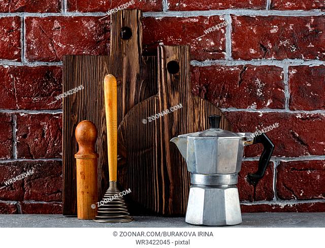 Two textured wooden cutting boards, italian espresso coffee pot - caffettiera and kitchen utensils
