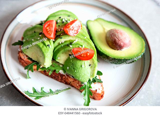 healthy breakfast with avocado and Delicious wholewheat toast. sliced avocado on toast bread with spices. Mexican cuisine/