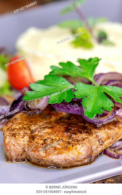 grilled pork steak with onions