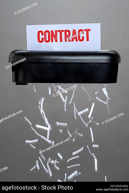 A shredder destroying a document - Contract