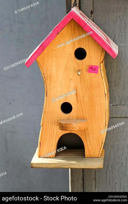 Wooden bird house with little round holes