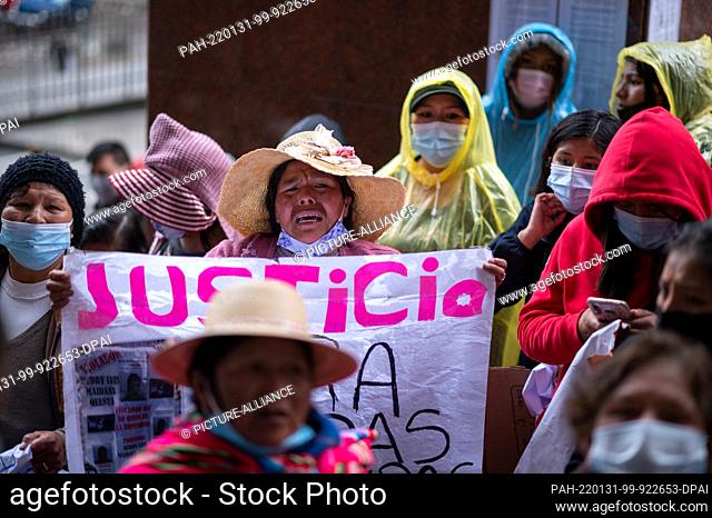 31 January 2022, Bolivia, La Paz: A woman shouts slogans and holds a placard with the word ""Justice"" during a protest against violence against women