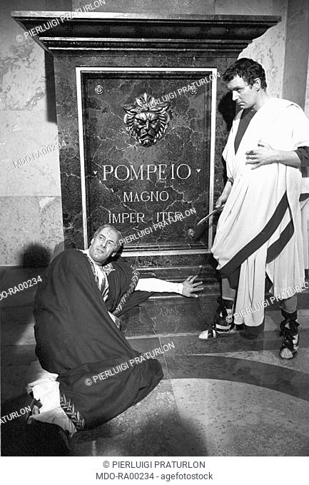 English actor Rex Harrison rehearsing the scene of Julius Caesar's death on the set of the film 'Cleopatra'. Rome, 1961