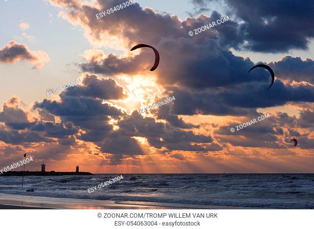 Kite surfing in the sunset at the beach of Scheveningen, the Netherlands